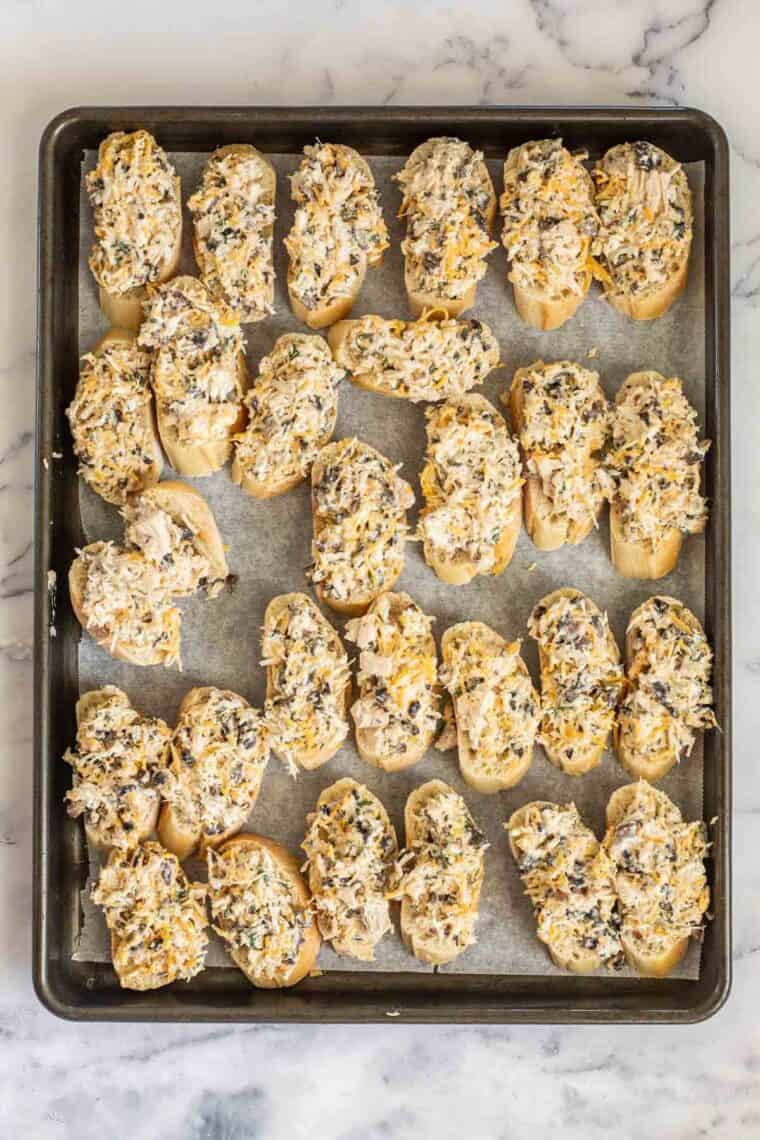 Assembled canapes in a baking sheet ready to bake. 