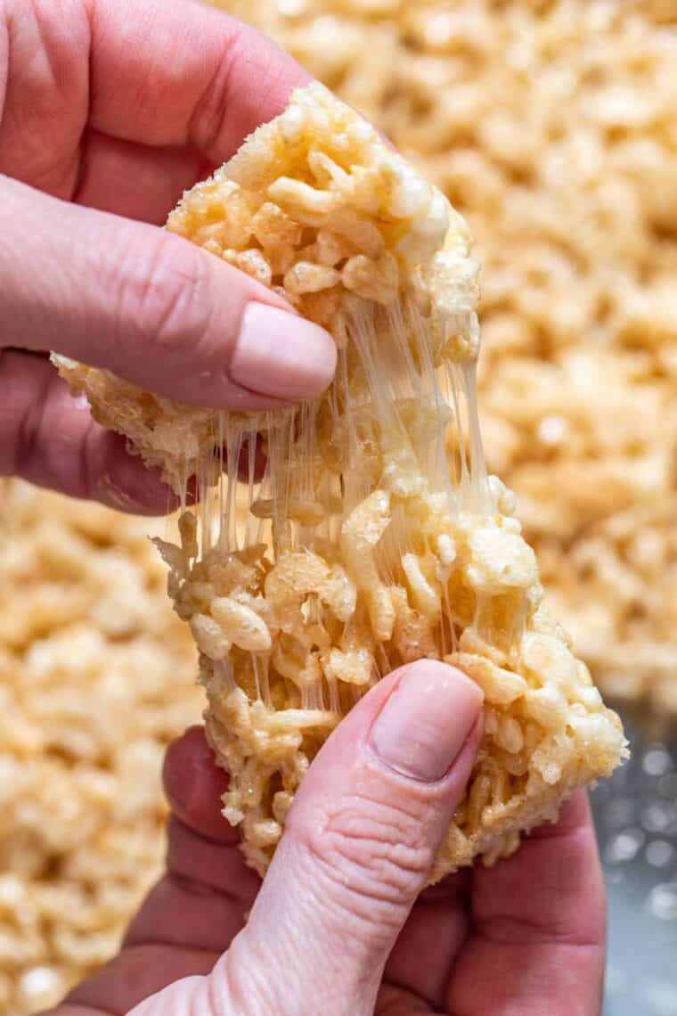 A piece of Rice Krispie treat being pulled apart. 
