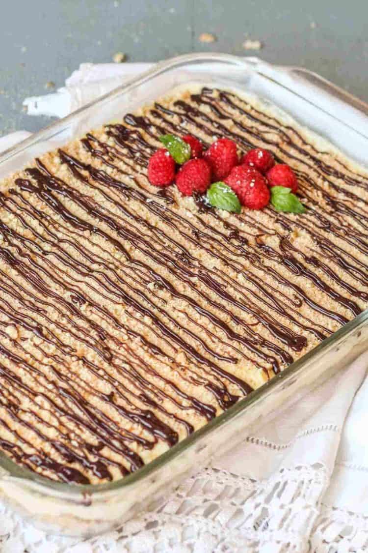 Delicious wafers and pudding dessert recipe topped with chocolate drizzle and fresh raspberries.