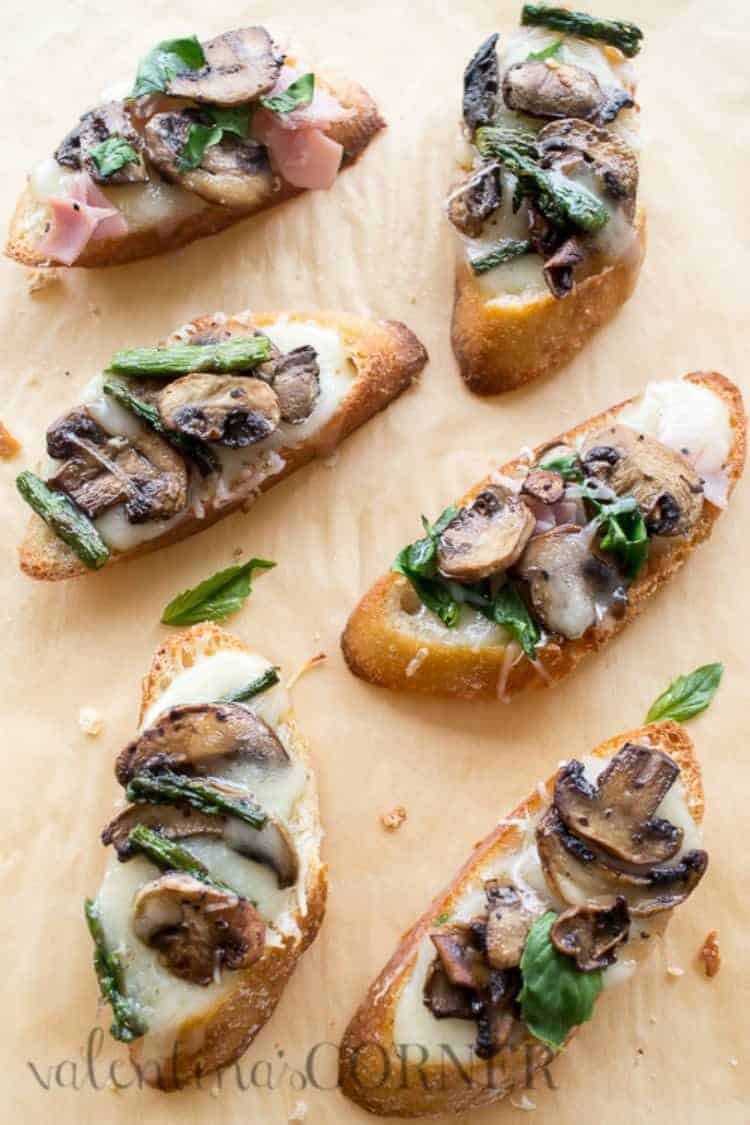 Toasted brie mushrooms canapes on a baguette topped with ham or asparagus.