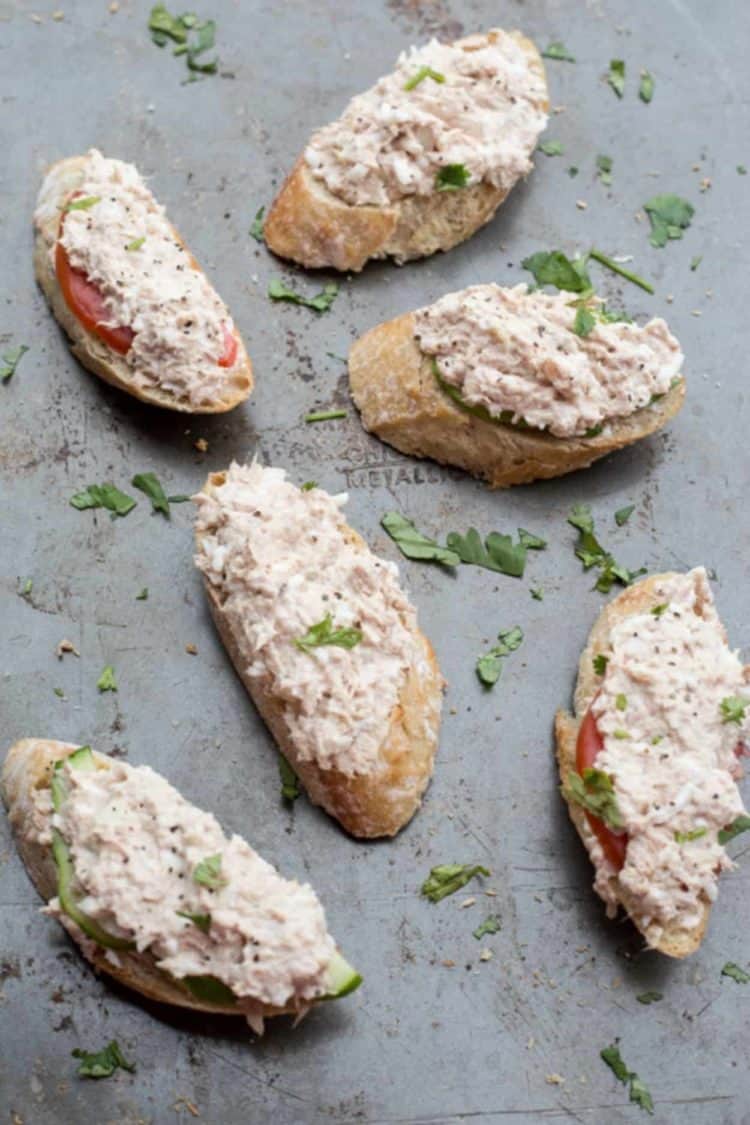 Tuna and egg canapes on with a creamy tuna spread, with tomatoes and avocados. Topped with fresh greens.