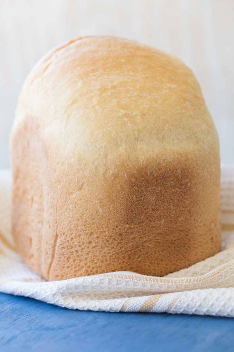 Loaf of bread machine bread on a towel.