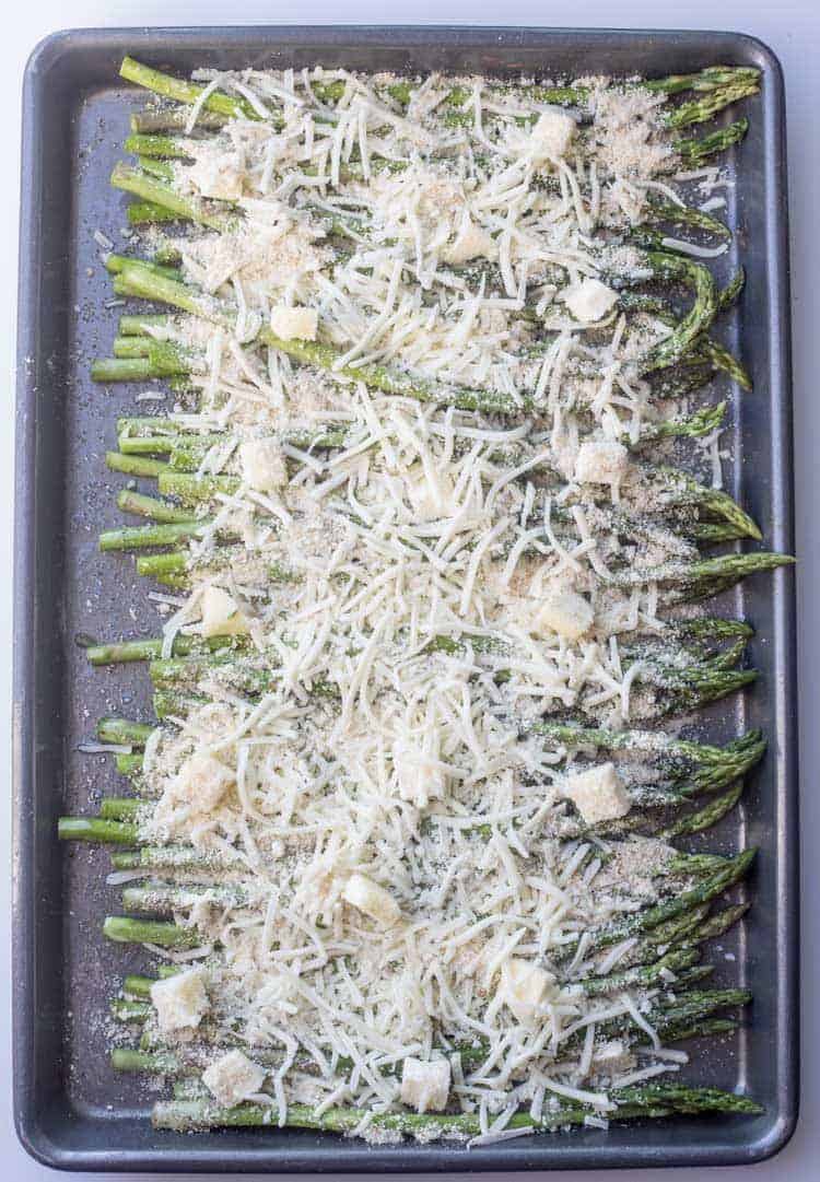  How to make cheesy baked asparagus recipe with cheese, butter and seasoned asparagus.