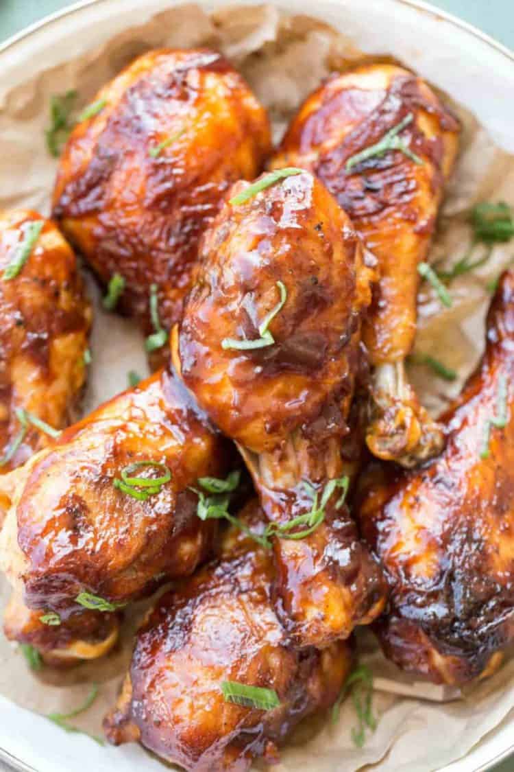 Close up picture of Baked barbecue chicken drumsticks in plate.