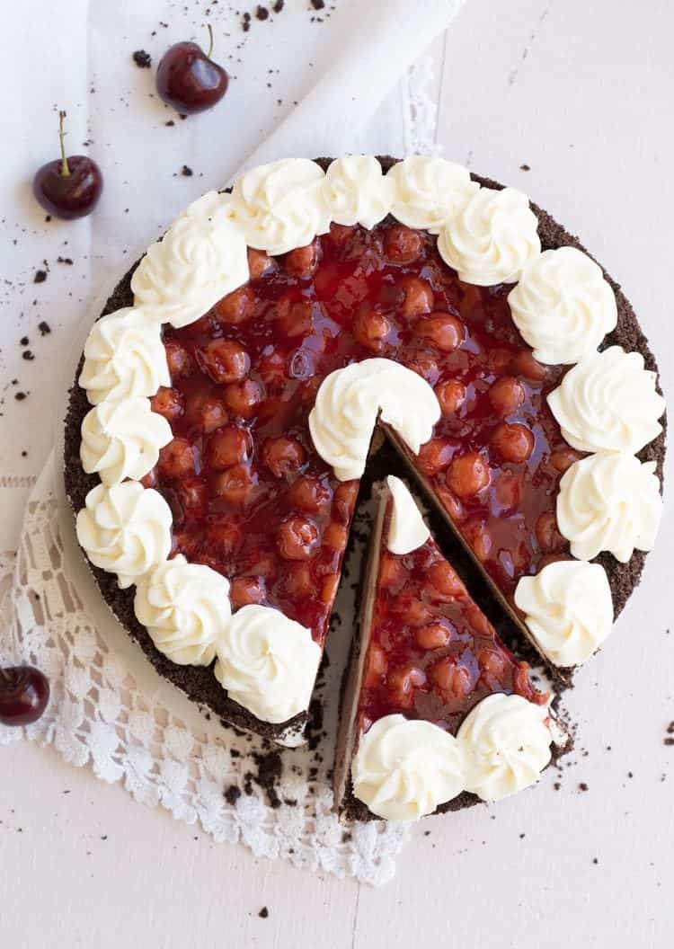 Easy no bake cherry blackforest cheesecake on a plate cut ito slices. 