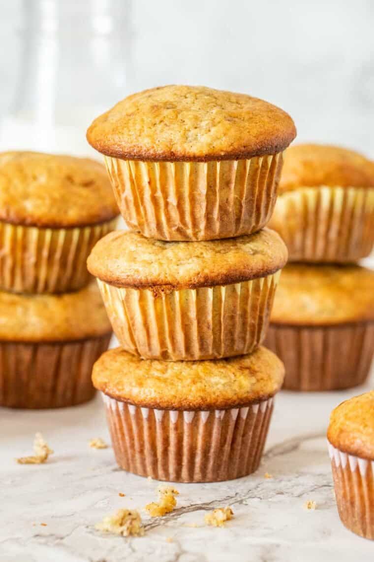 Three banana bread muffins stacked on top of each other. 