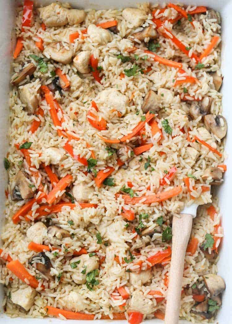Oven Baked Chicken and Rice with Vegetables topped with greens.