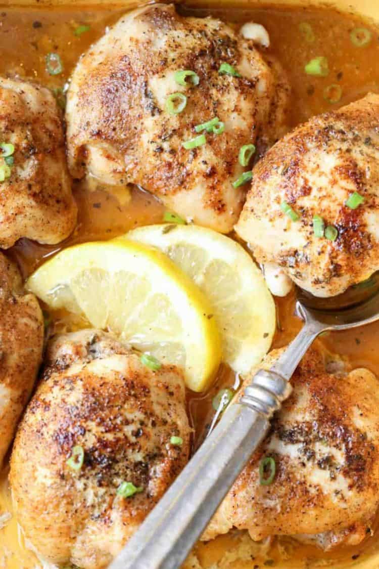 Baked Lemon Butter Chicken Thighs in a pan with lemon.