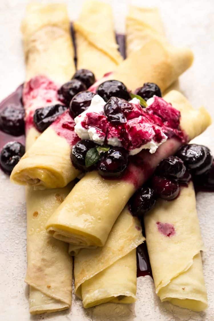 Crepes with a custard filling topped with a blueberry sauce and whipped creme!