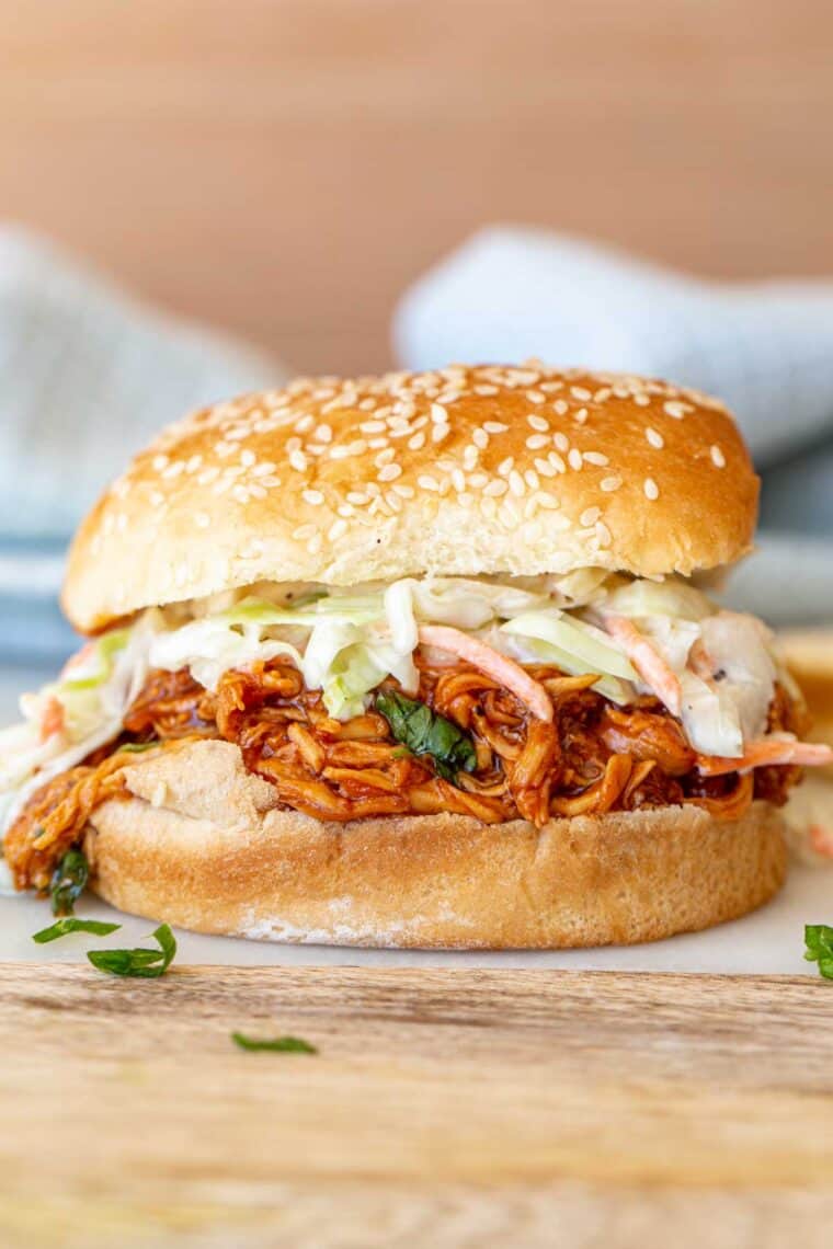 BBQ pulled chicken made as a sandwich loaded with coleslaw. 