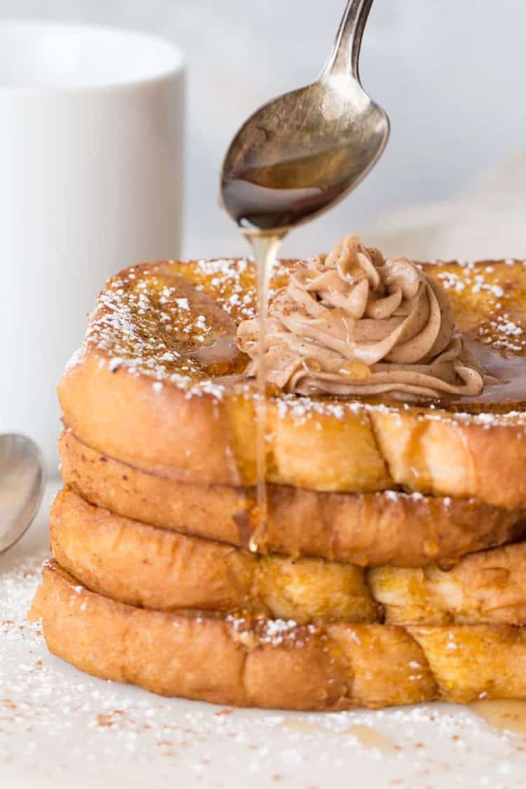 Easy French toast stacked on top of each other with maple syrup drizzle on top.