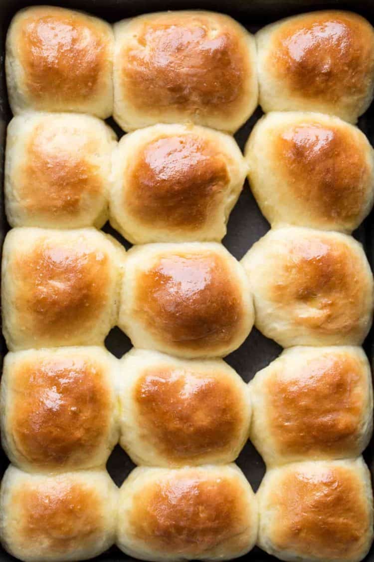 Soft dinner rolls in a baking sheet.
