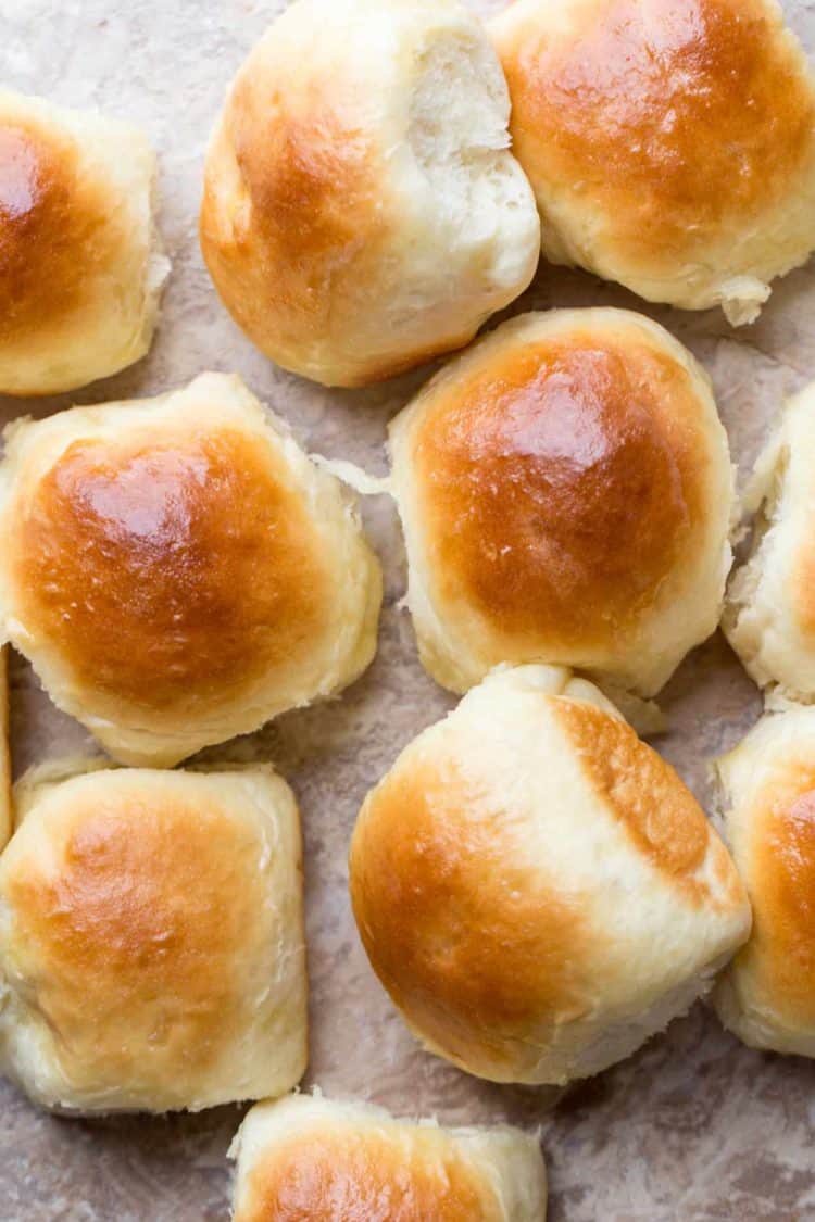 Buttery dinner rolls laid out on a board. 