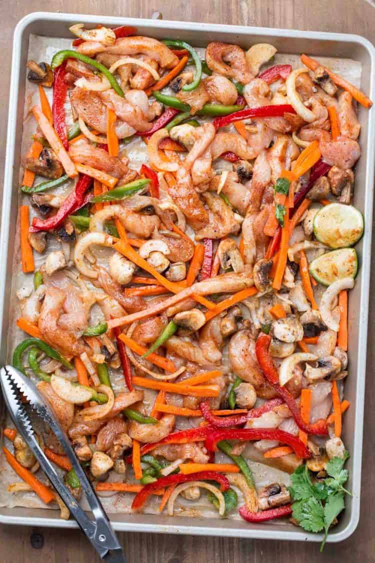 Chicken vegetable fajitas in a baking dish ready to go in the oven.