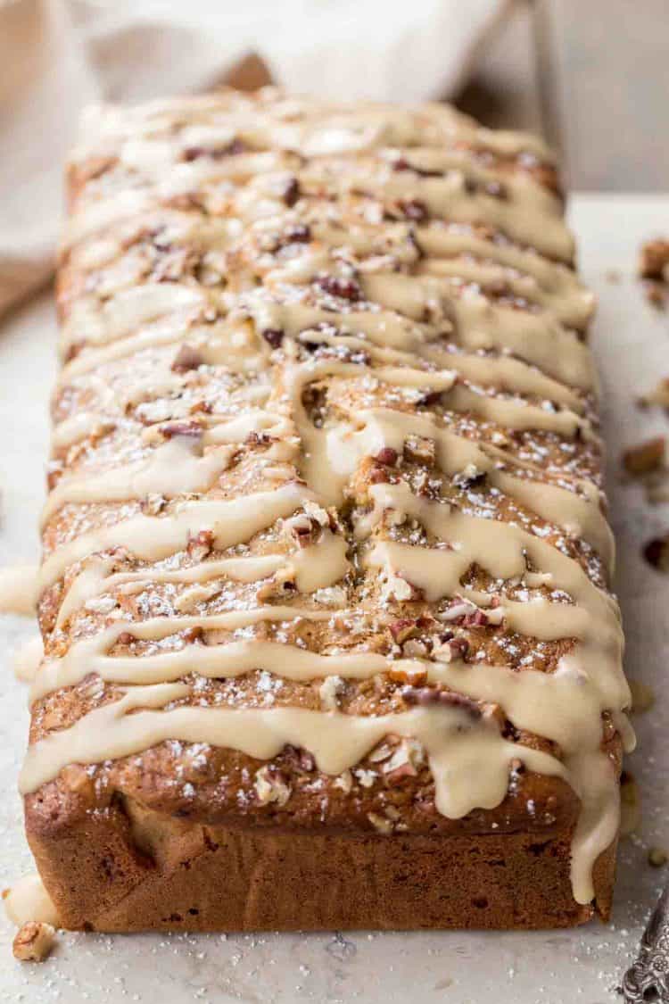 Banana bread loaf topped with a homemade glaze and powdered sugar. 