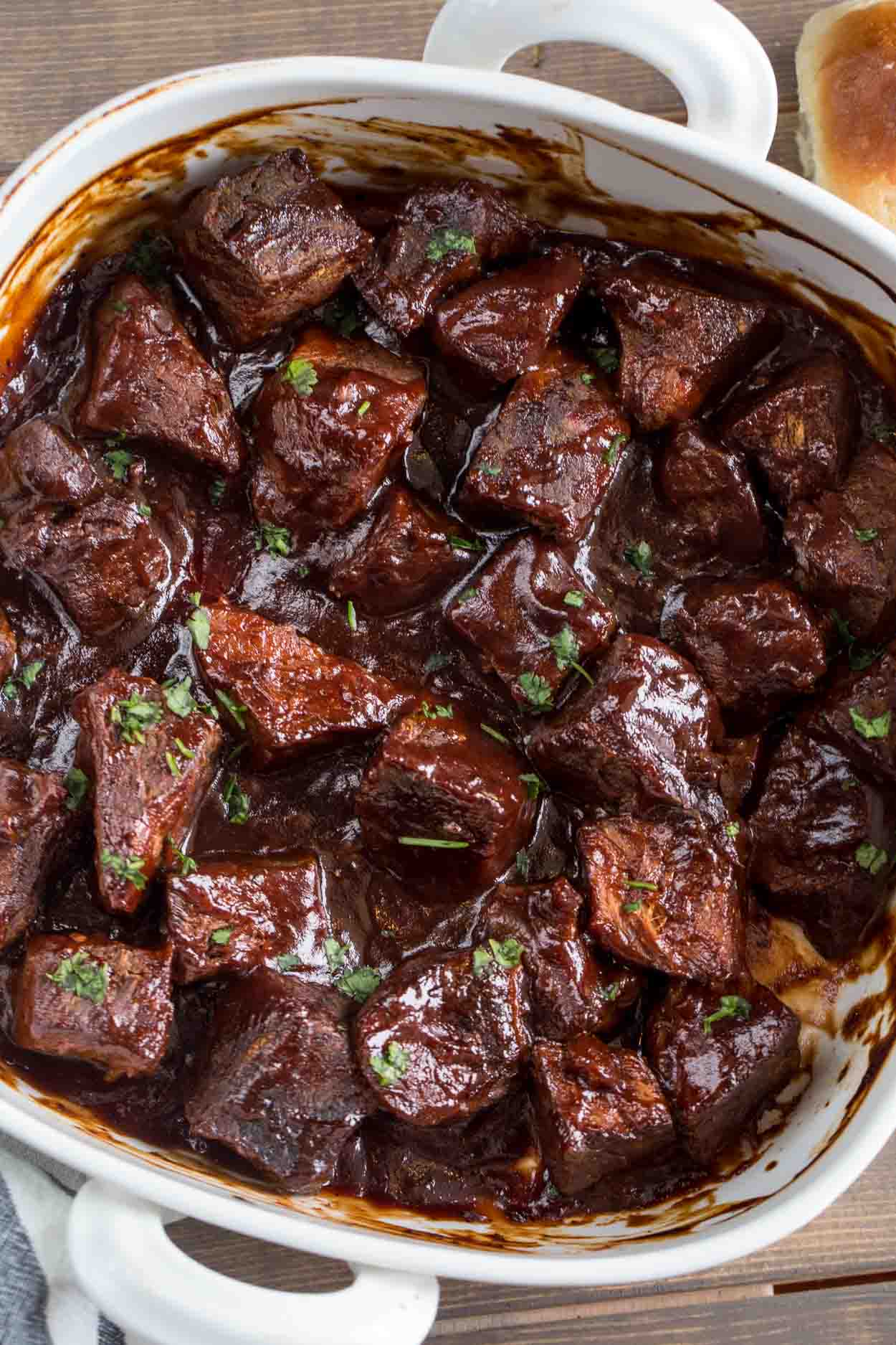 BBQ Crockpot Roast with a tangy barbecue sauce, topped with greens.