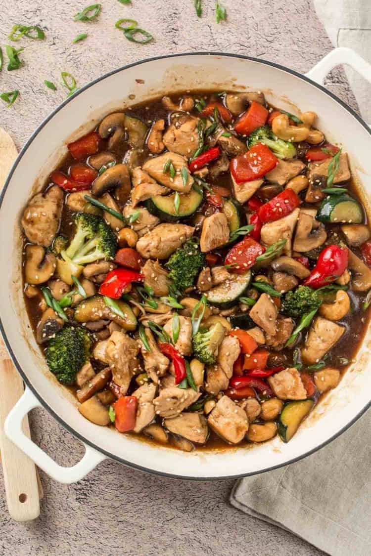 Easy stir fry recipe with chicken, broccoli, zucchini, mushrooms, peppers, carrots and cashews in a homemade stir fry sauce.