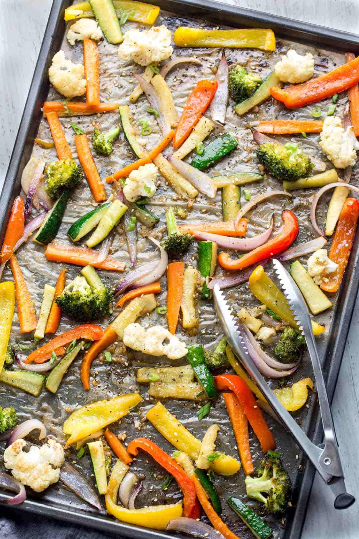Roasted vegetables on a baking sheet, roasted into tender vegetables.