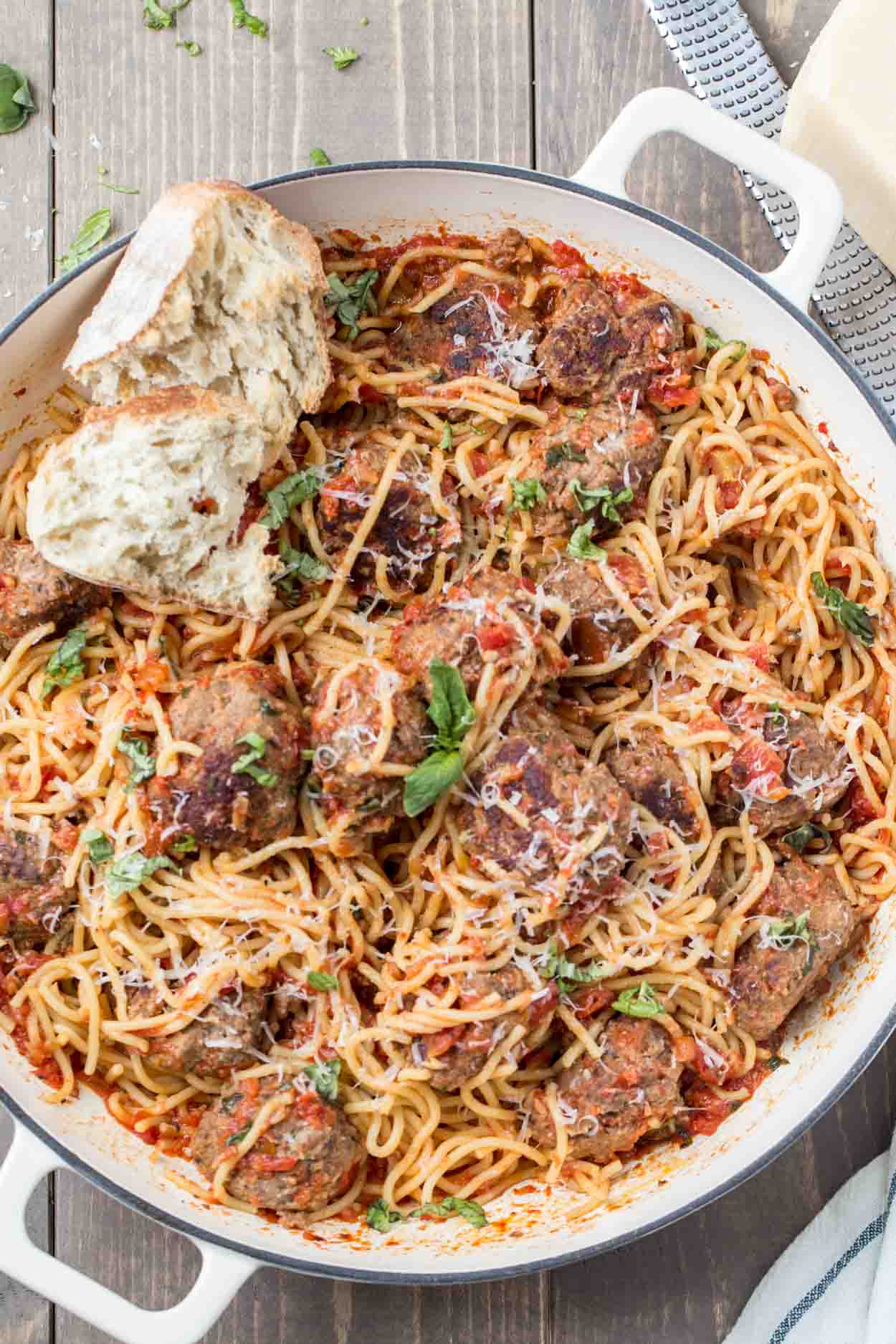 Spaghetti and meatballs recipe made with homemade meatballs in a large pot with Italian bread. 
