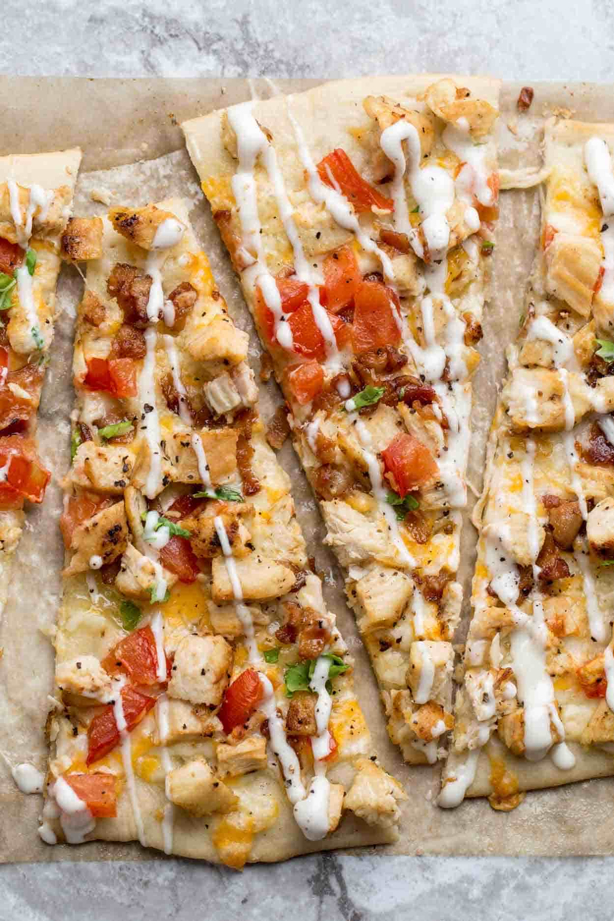 Thin and crispy flatbread crust topped with cheeses, chicken, bacon, avocado and drizzled with Ranch.