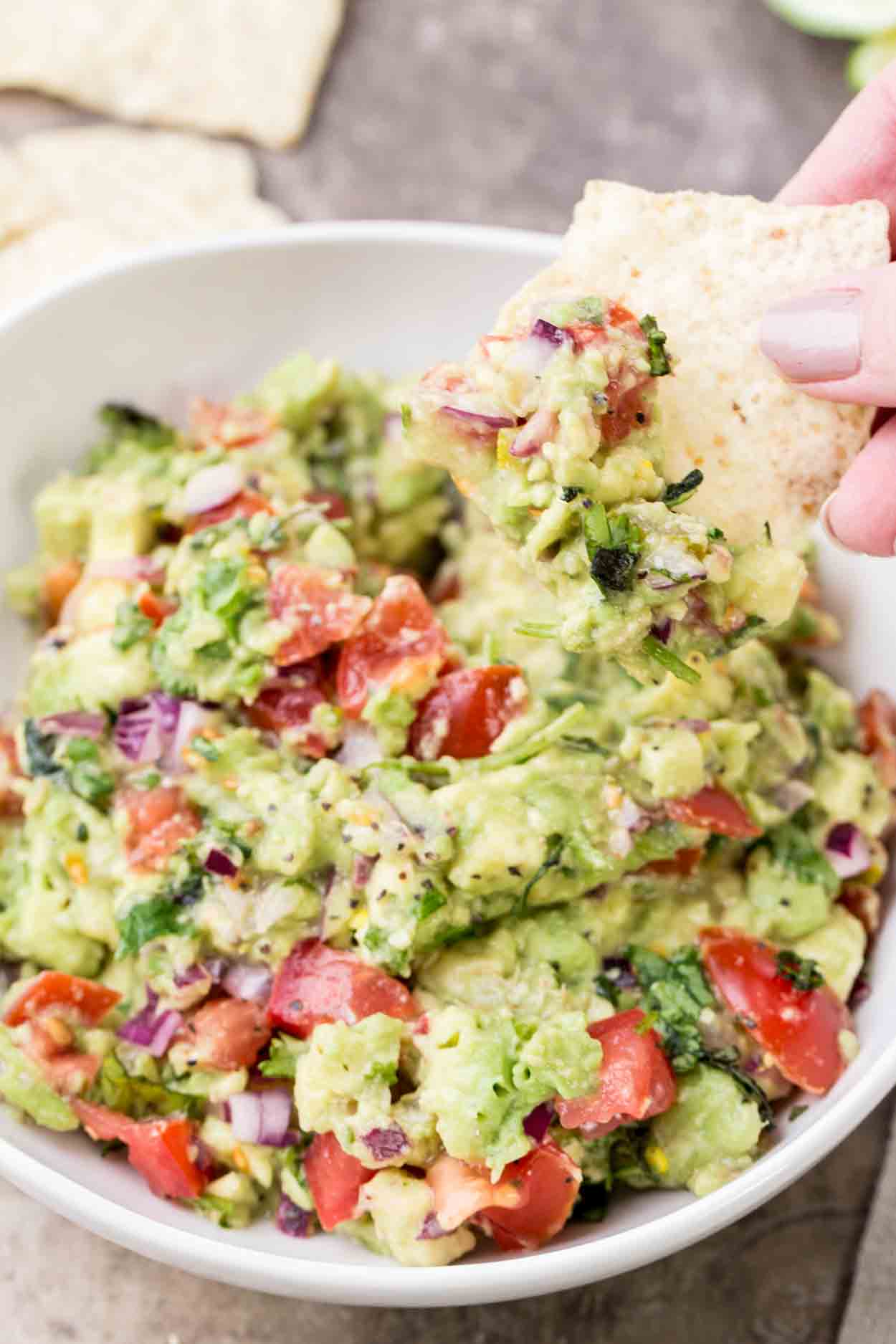 Fresh authentic and easy guacamole in a bowl with chips.