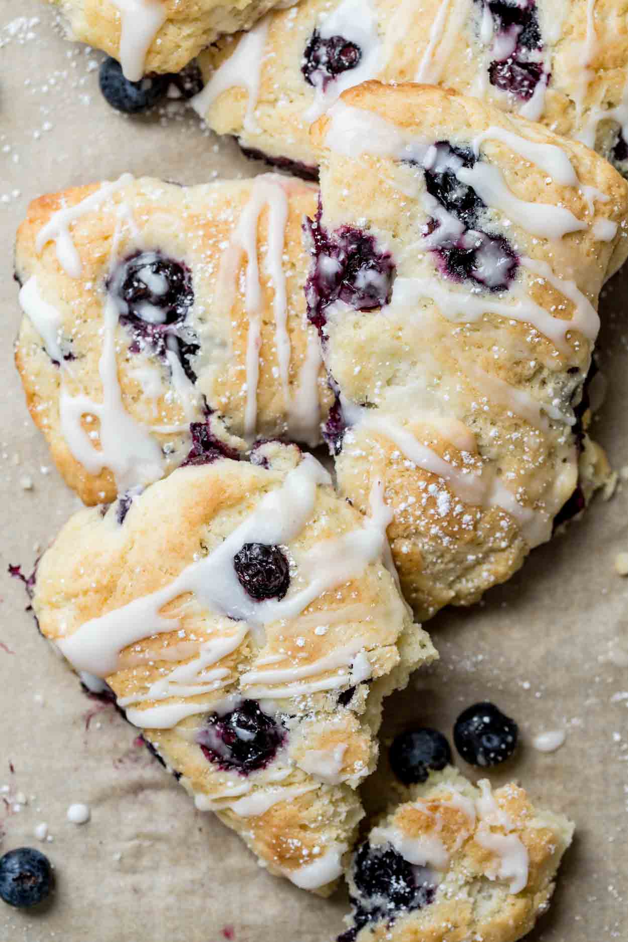 Three scones laid on top of each other, drizzled in glaze.