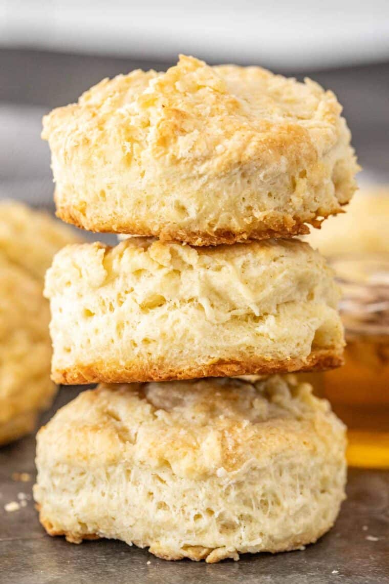 Three homemade biscuits stacked on top of each other. 