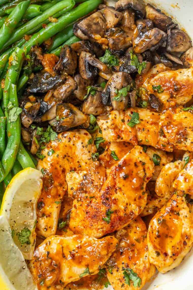 Garlic lemon chicken with mushrooms and greens beans topped with fresh chopped greens. 