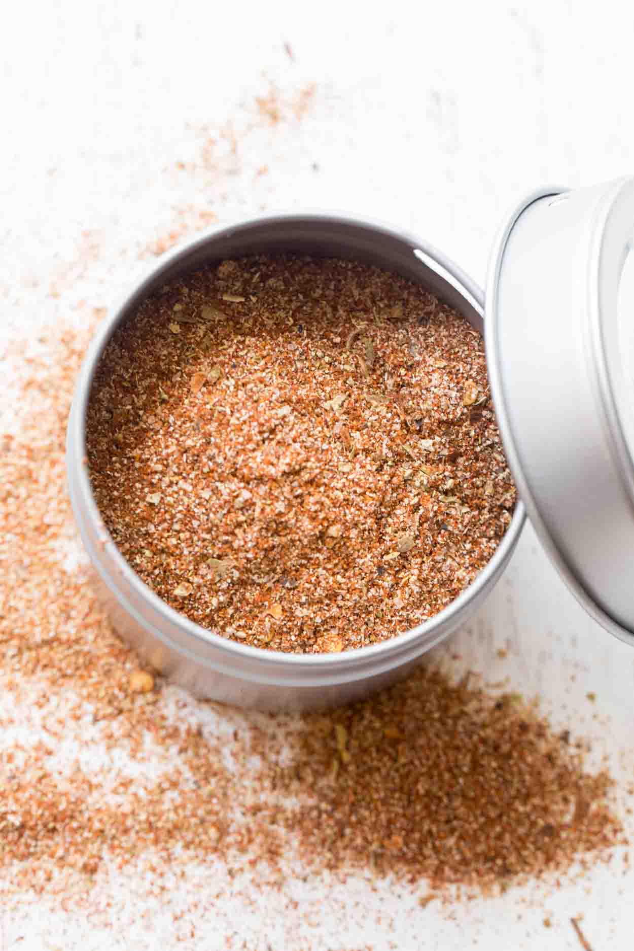 Taco seasonings recipe in a container with the lid next to it. 
