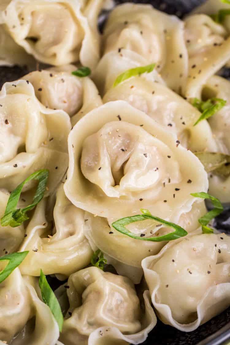 Won ton wrappers filled with the classic Russian dumpling meat filling topped with fresh greens.