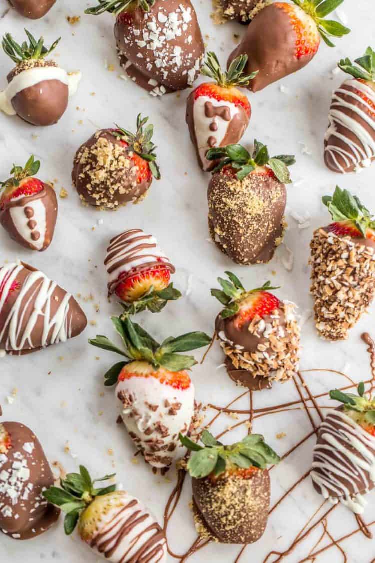 Chocolate covered strawberries on a platter with chocolate drizzle. 