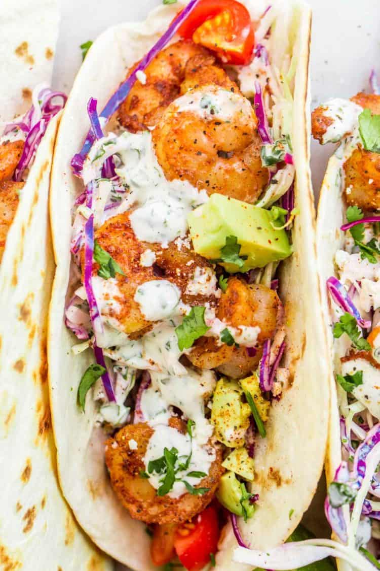 A shrimp taco loaded with seasoned shrimp, cabbage slaw, and creamy cilantro lime dressing.