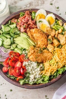 A salad bowl packed with cobb salad toppings.