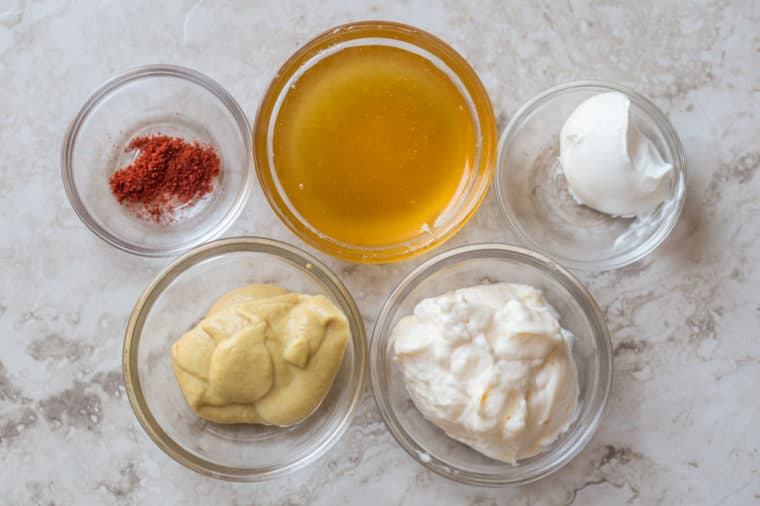 All the ingredients needs for homemade honey mustard sauce.