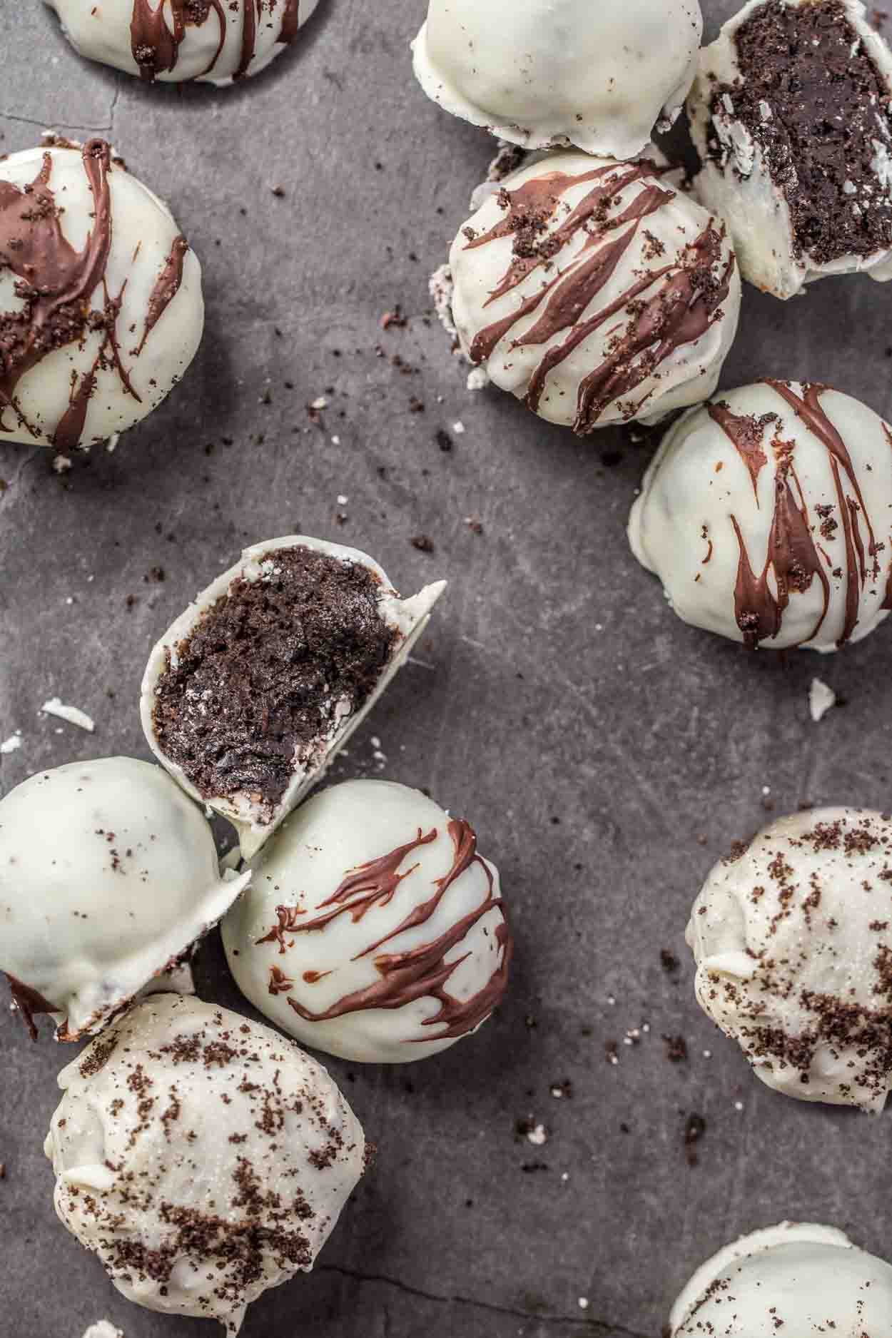 White chocolate covered oreo balls laid out topped with crushed oreo.