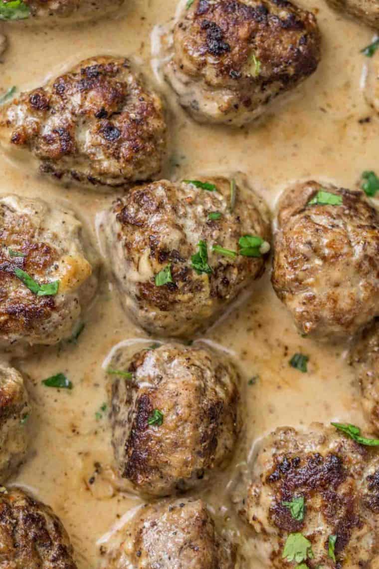 Juicy and tender meatballs in a creamy sauce topped with fresh chopped greens. 
