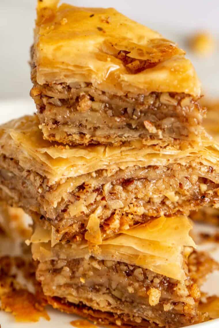 Slices of homemade baklava stacked on top of each other. 
