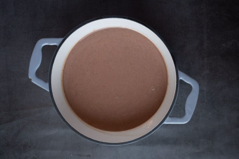 A small saucepan filled with hot chocolate. 
