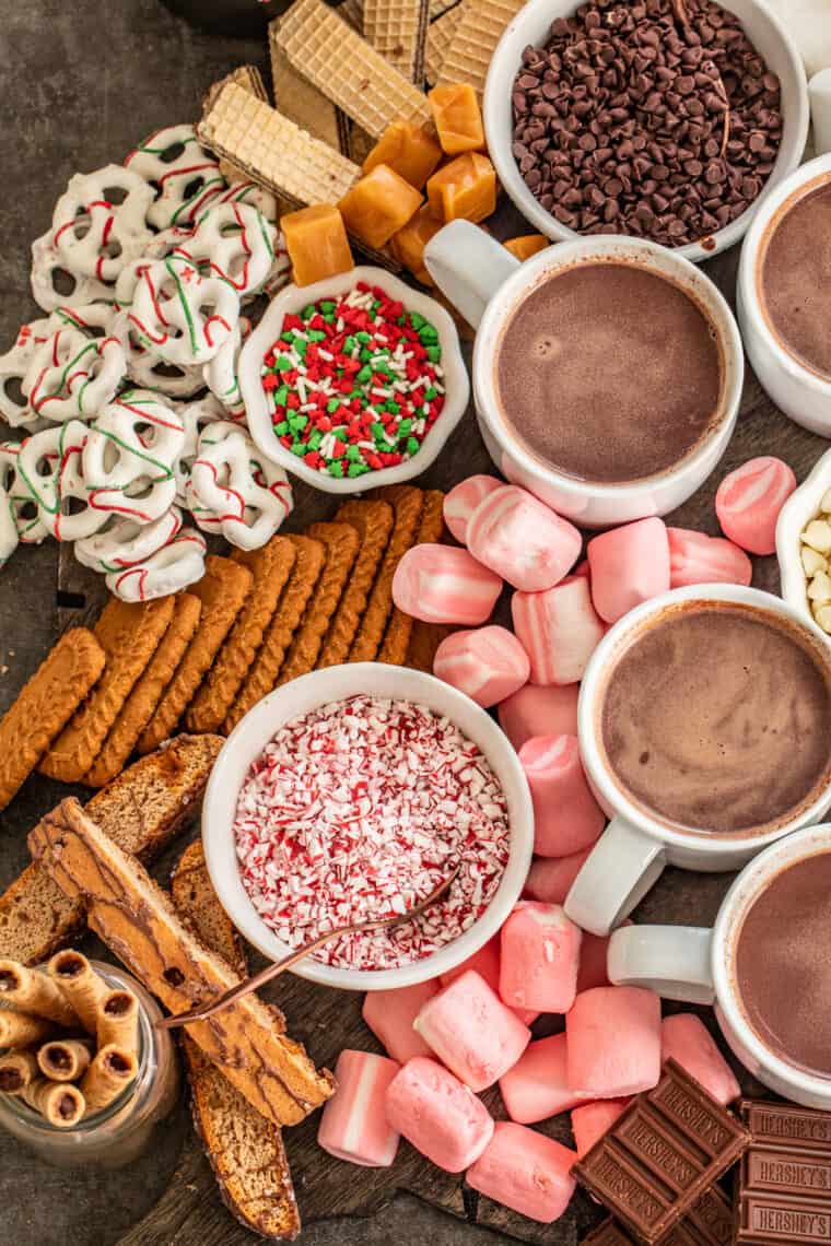 Hot chocolate bar laid out with cups of hot cocoa.