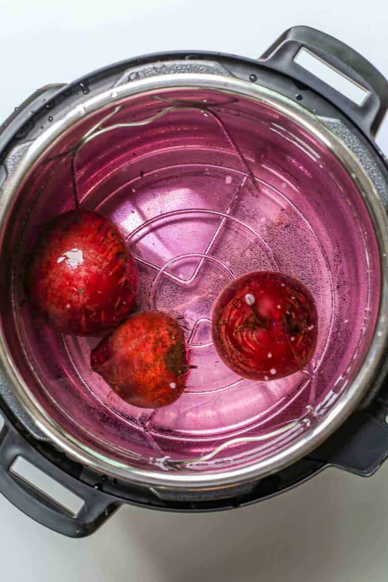 Uncooked beets in an instant pot with water. 