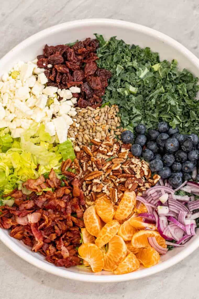 Kale salad unmixed with all the ingredients laid out. 
