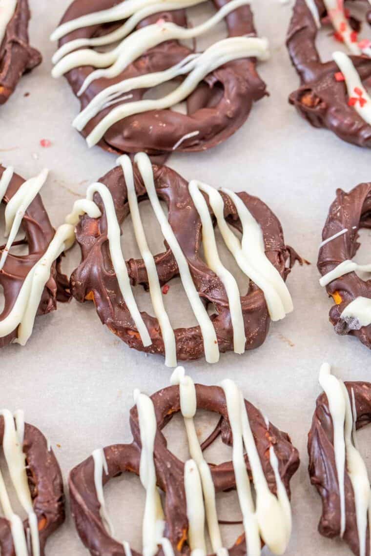 Chocolate covered pretzles laid out on a baking sheet. 