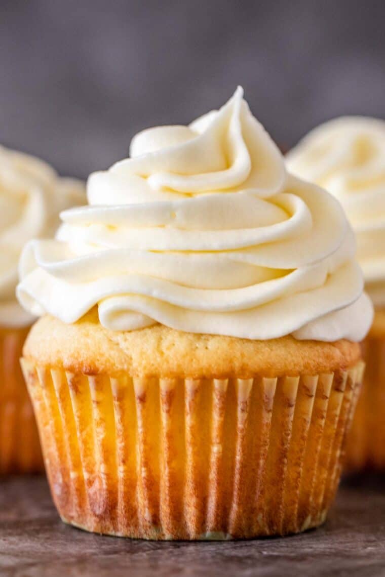 Cream cheese vanilla frosting piped on top of classic cupcakes. 