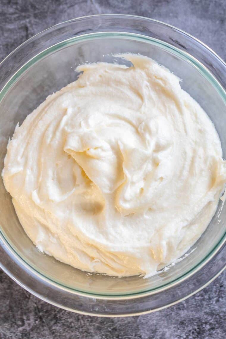 A glass bowl of cream cheese buttercream frosting.