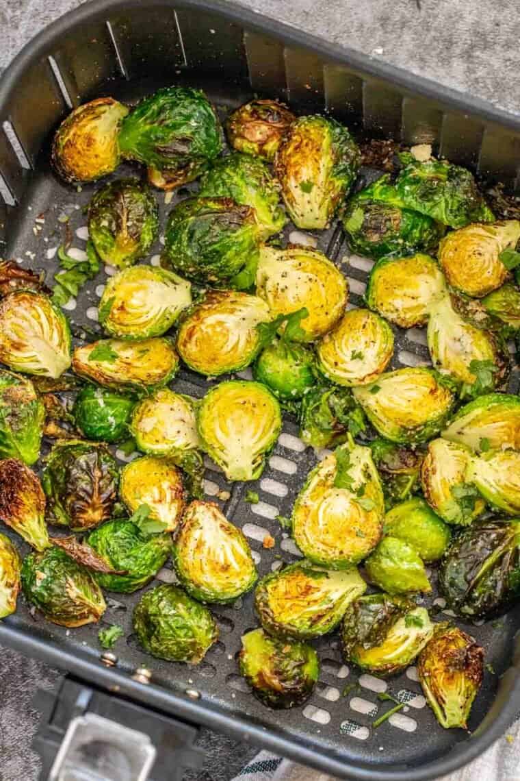 Crispy roasted brussel sprouts in the air fryer basket. 