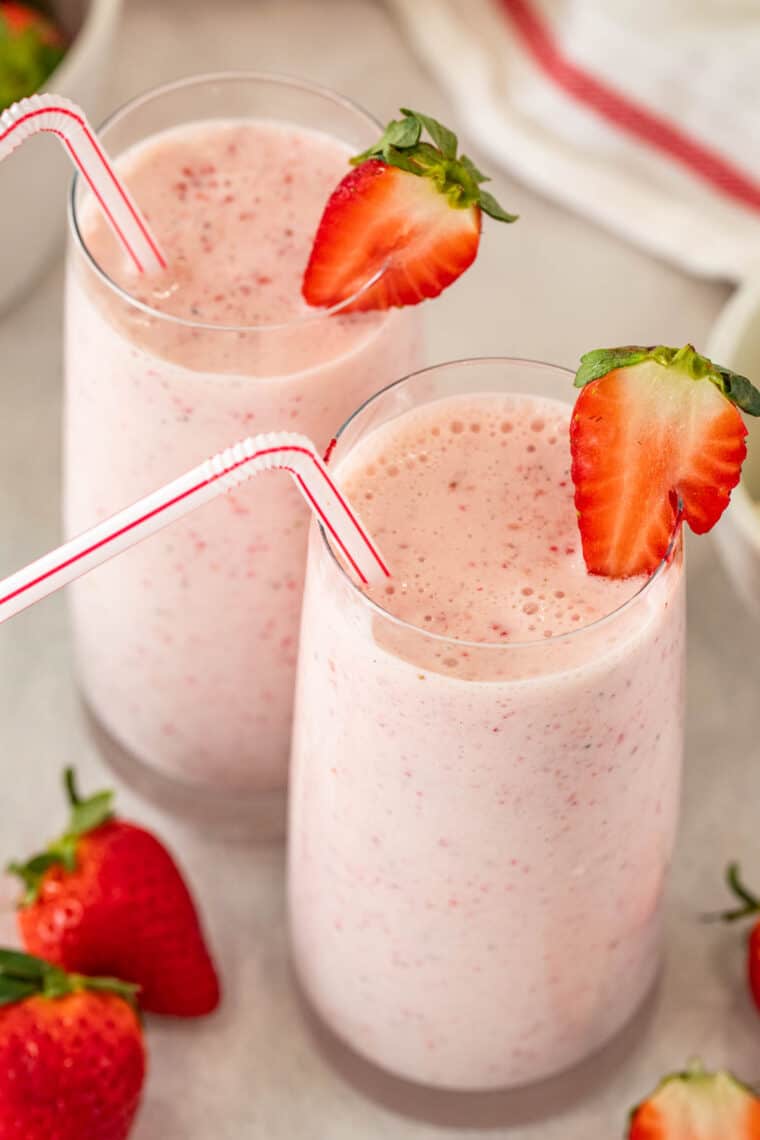 Top view of two glassses of homemade strawberry milkshake. 