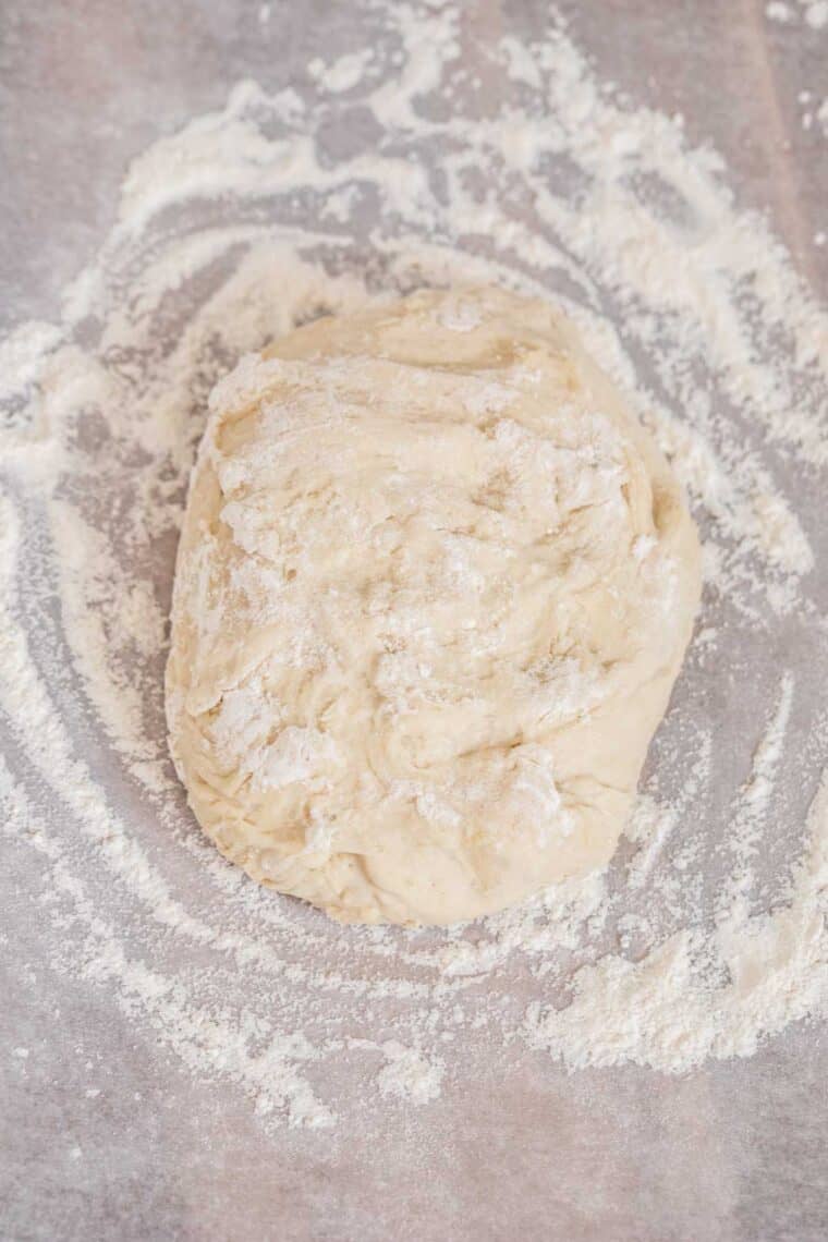 Flatbread dough topped with all-purpose flour. 