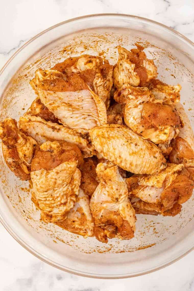 A glass bowl with the chicken wings in the homemade grilled chicken marinade. 