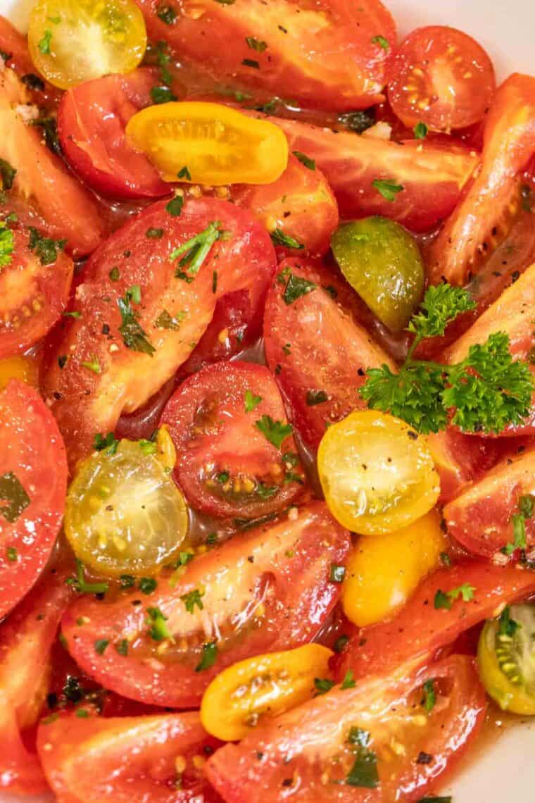 Marinated tomatoes topped with freshly chopped parsley. 