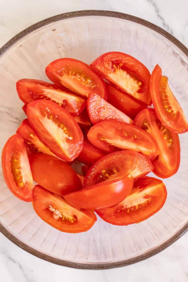 Sliced tomatoes in a glass bowl. 